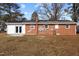 Brick exterior of house with visible pipes, windows, electrical boxes, and new solar panels at 5088 Christian Light Rd, Fuquay Varina, NC 27526