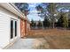 Exterior side view showing a brick house, white siding, and a brick patio with french doors at 5088 Christian Light Rd, Fuquay Varina, NC 27526