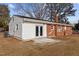 Exterior side of the house with brick and white siding plus a patio area with french doors at 5088 Christian Light Rd, Fuquay Varina, NC 27526