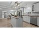 Well-lit kitchen features an island, stainless steel appliances, white cabinets, granite countertops, and an adjacent dining area at 5088 Christian Light Rd, Fuquay Varina, NC 27526