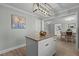 Modern kitchen with white island, granite countertops, and stainless steel appliances at 5088 Christian Light Rd, Fuquay Varina, NC 27526