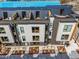 Modern townhomes featuring rooftop patios, gray and white siding, and landscaped front yards at 512 Gordon Street # 303, Durham, NC 27701