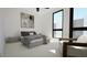 Stylish bedroom with a large window, bedside tables, and a comfortable seating area at 512 Gordon Street # 303, Durham, NC 27701