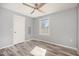 Spacious bedroom with gray walls, wood-look floors, and a ceiling fan at 513 Woods St, Durham, NC 27703