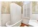 Charming bathroom with clawfoot tub, white subway tile and window at 517 N East St, Raleigh, NC 27604