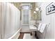 Updated bathroom with white subway tile, pedestal sink, and shower/tub combo at 517 N East St, Raleigh, NC 27604