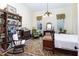 Charming bedroom with hardwood floors, built-in bookcase and rocking chair at 517 N East St, Raleigh, NC 27604