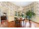 Bright dining room with hardwood floors, floral wallpaper and view into kitchen at 517 N East St, Raleigh, NC 27604