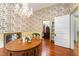 Spacious dining room with hardwood floors, floral wallpaper, and ample natural light at 517 N East St, Raleigh, NC 27604
