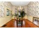 Charming dining room features hardwood floors, floral wallpaper, and built-in hutch at 517 N East St, Raleigh, NC 27604