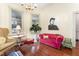 Living room featuring hardwood floors, a vibrant sofa, and large artwork at 517 N East St, Raleigh, NC 27604