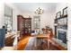 Home office with hardwood floors, built-in bookcase, and fireplace at 517 N East St, Raleigh, NC 27604