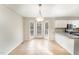 Eat-in kitchen with bay window, white cabinets, and tile floors at 5504 Ocracoke Ct, Raleigh, NC 27610