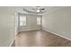 Spacious bedroom with wood-look floors and two large windows at 608 Senter View Dr, Fuquay Varina, NC 27526