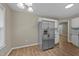 Kitchen features stainless steel refrigerator, white cabinets, and hardwood floors at 608 Senter View Dr, Fuquay Varina, NC 27526