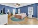 Spacious bedroom with blue walls, wood floors, and en-suite bathroom at 6421 Grassy Knoll Ln, Raleigh, NC 27616