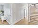 Light hallway with wood floors and doors at 6421 Grassy Knoll Ln, Raleigh, NC 27616