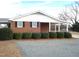 Brick ranch home with covered porch and neat landscaping at 6793 Stricklands Crossroads Rd, Four Oaks, NC 27524