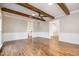 Open living area with hardwood floors, white wainscoting and exposed beams at 704 Misty Isle Pl, Raleigh, NC 27615