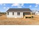 View of the rear exterior of the home with gray siding and a small deck at 75 Brookhaven Dr, Spring Hope, NC 27882