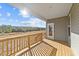 A covered back porch with wooden railings and a scenic view of trees and sky at 75 Brookhaven Dr, Spring Hope, NC 27882