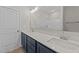Bright bathroom featuring double sinks, sleek fixtures, and a well-lit vanity area at 75 Brookhaven Dr, Spring Hope, NC 27882
