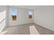 Bright bedroom with neutral carpeting and two large windows at 75 Brookhaven Dr, Spring Hope, NC 27882