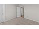 A bedroom with neutral walls, plush carpeting, and open doorway leading to other rooms at 75 Brookhaven Dr, Spring Hope, NC 27882