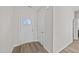 Front entry with white door and wood-look flooring at 75 Brookhaven Dr, Spring Hope, NC 27882
