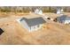 Aerial view of a new construction home with a wooden deck and a spacious, empty yard at 75 Brookhaven Dr, Spring Hope, NC 27882