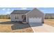 Charming home showcasing a gray exterior, attached garage, and front entrance at 75 Brookhaven Dr, Spring Hope, NC 27882