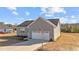 Gray sided home with an attached garage and concrete driveway at 75 Brookhaven Dr, Spring Hope, NC 27882