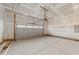 A spacious two-car garage featuring a modern garage door and concrete flooring at 75 Brookhaven Dr, Spring Hope, NC 27882