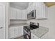 Modern kitchen with white cabinets and granite countertops at 75 Brookhaven Dr, Spring Hope, NC 27882