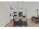 Well-lit kitchen boasts white cabinets, stainless steel appliances, and an island with bar seating at 75 Brookhaven Dr, Spring Hope, NC 27882