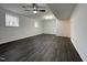 Large basement recreation room featuring gray vinyl flooring at 7780 Brookdale Dr, Raleigh, NC 27616