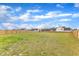 A large, grassy backyard is enclosed by a wood fence, offering privacy at 8 Looping Horse Cir, Angier, NC 27501