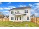 White two-story home with a spacious backyard and a private wooden fence at 8 Looping Horse Cir, Angier, NC 27501