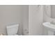 This half bathroom offers a pedestal sink and a modern toilet for convenience at 8 Looping Horse Cir, Angier, NC 27501