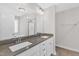 Modern bathroom featuring double sink vanity, large mirror, and a shower with glass door at 8 Looping Horse Cir, Angier, NC 27501