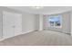 A bedroom boasts soft carpet, natural light, and white double door closet at 8 Looping Horse Cir, Angier, NC 27501