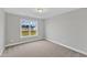 This bedroom features neutral walls, carpet, and a window overlooking the backyard at 8 Looping Horse Cir, Angier, NC 27501