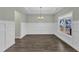 Bright dining room featuring hardwood floors, wainscoting and chandelier at 8 Looping Horse Cir, Angier, NC 27501