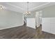 Open dining room with hardwood floors, wainscoting, and chandelier lighting at 8 Looping Horse Cir, Angier, NC 27501