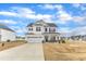 View of a white two-story home featuring a covered porch, black shutters, and a two car garage at 8 Looping Horse Cir, Angier, NC 27501