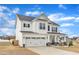 Charming two-story home with a white exterior, a two-car garage, and a well-maintained lawn at 8 Looping Horse Cir, Angier, NC 27501
