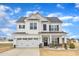 Charming two-story home with white siding, black shutters, covered porch, and a two car garage at 8 Looping Horse Cir, Angier, NC 27501
