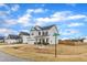 Two-story home at street corner with manicured lawn, white exterior, and covered front porch at 8 Looping Horse Cir, Angier, NC 27501