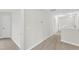 Upstairs hallway featuring carpet, neutral walls, and multiple doorways at 8 Looping Horse Cir, Angier, NC 27501