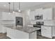 Kitchen island featuring granite countertop, stainless steel appliances and white cabinetry at 8 Looping Horse Cir, Angier, NC 27501
